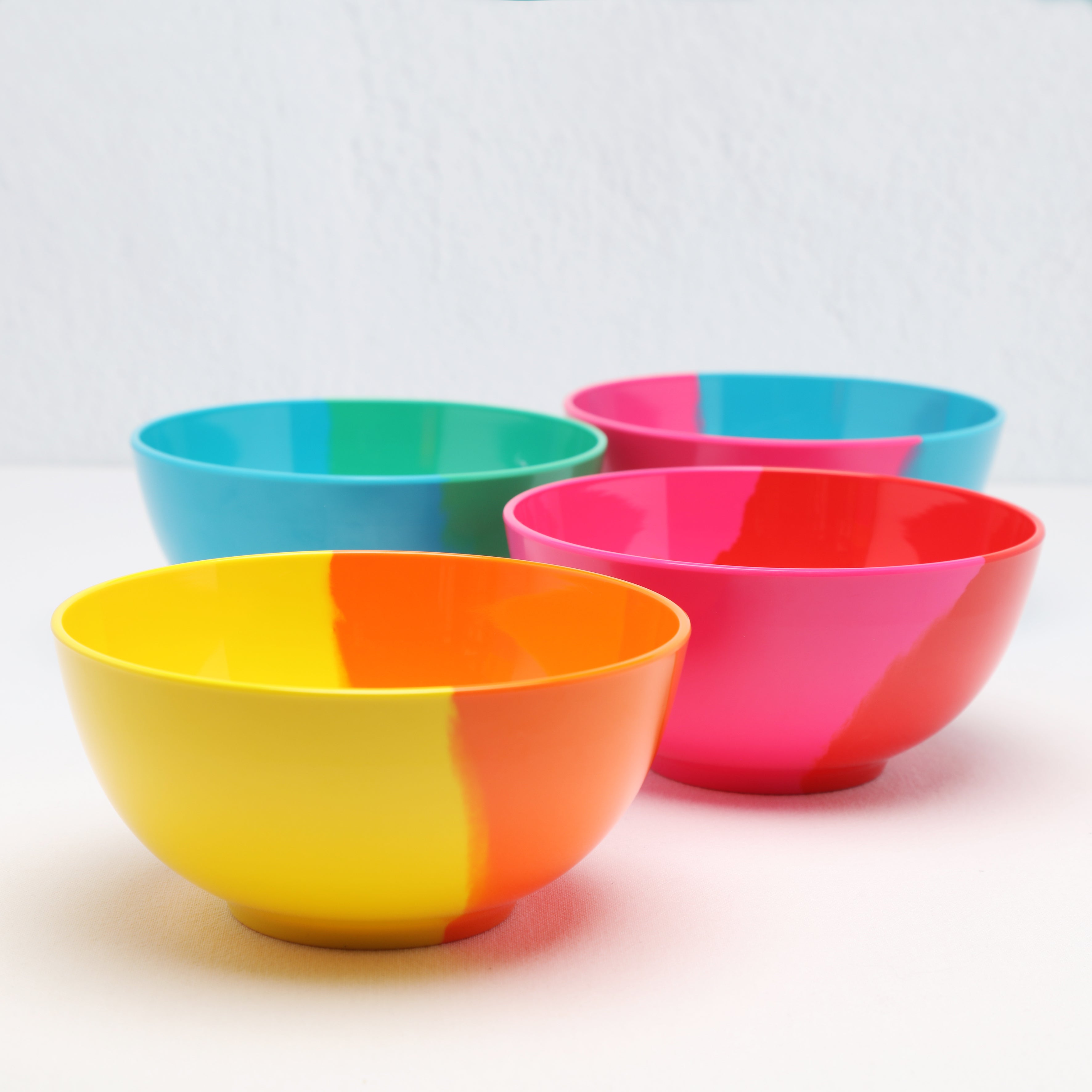 Four Prue Leith melamine Bowls on white background angle view
