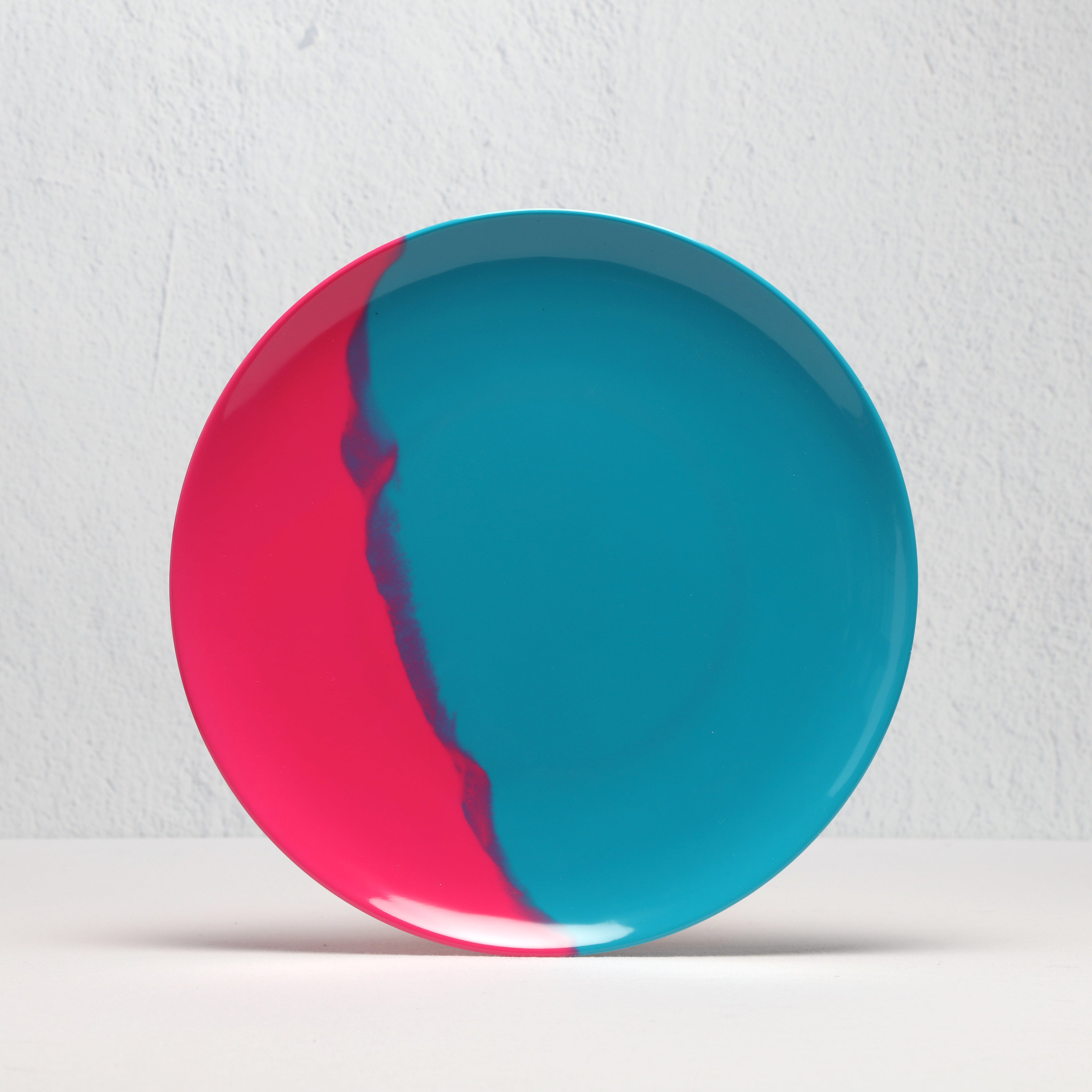 Round plate with red and blue design on a white background