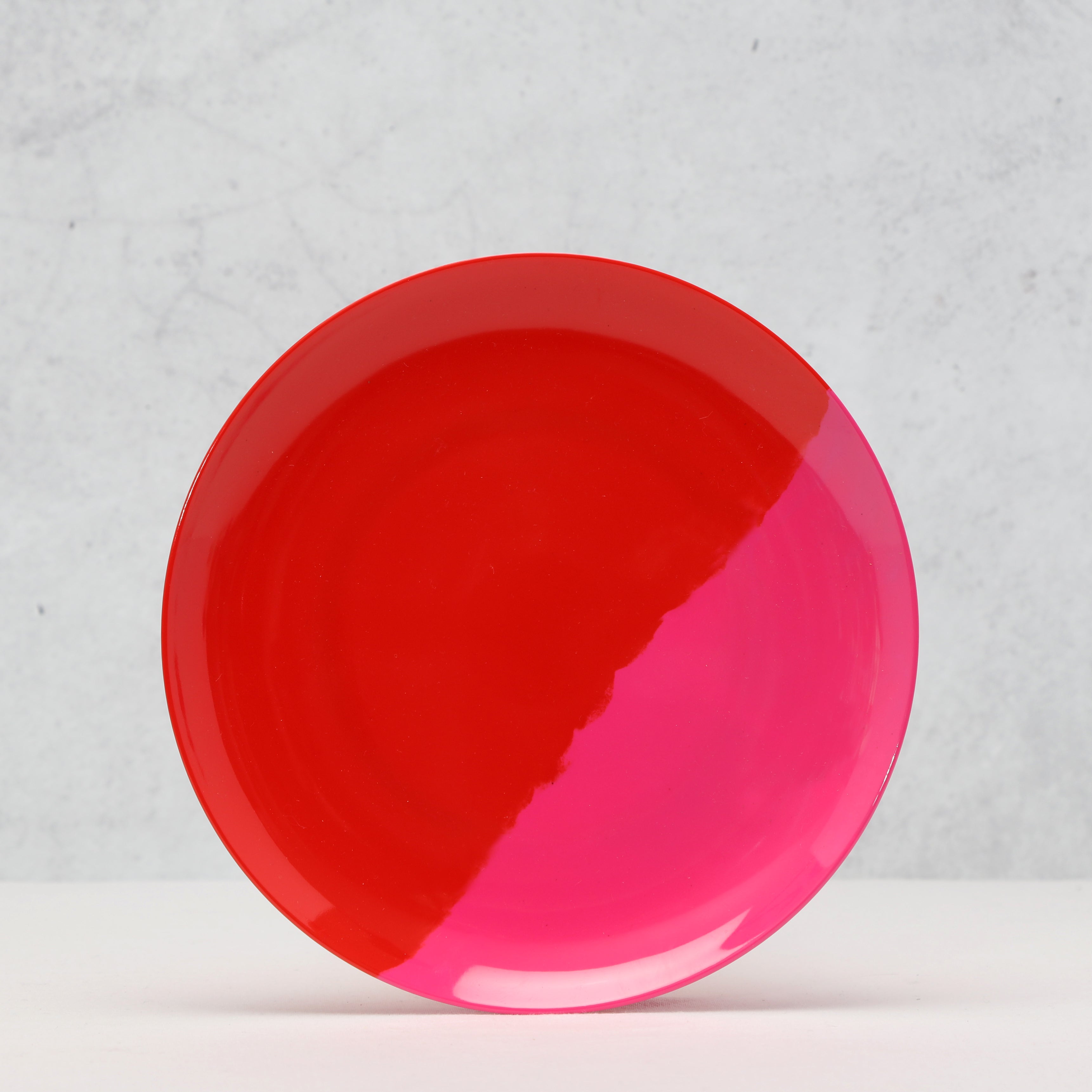 red and pink melamine plate on a light gray background