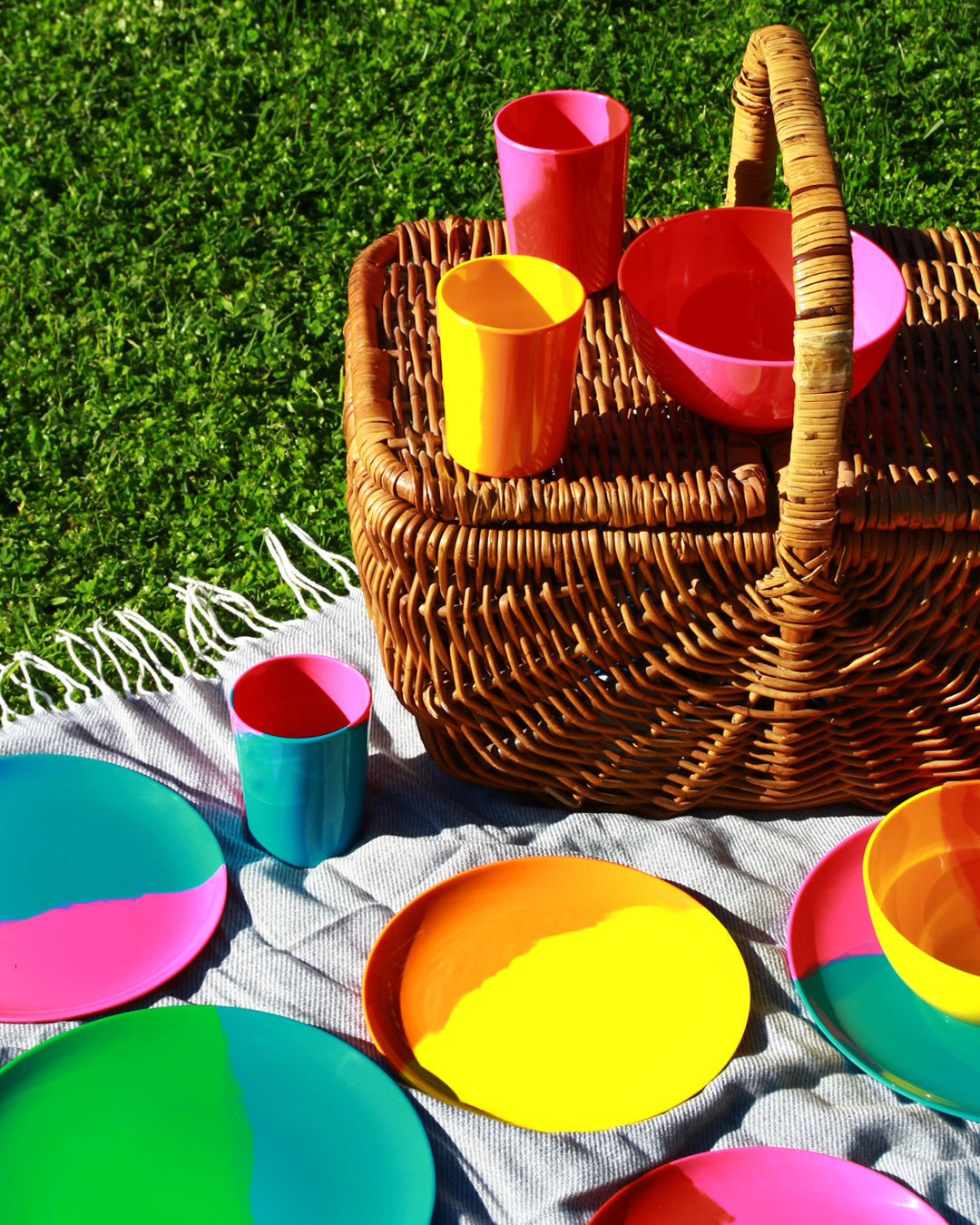 Picnic scene with Prue Leith colourful melamine on a rug with basket