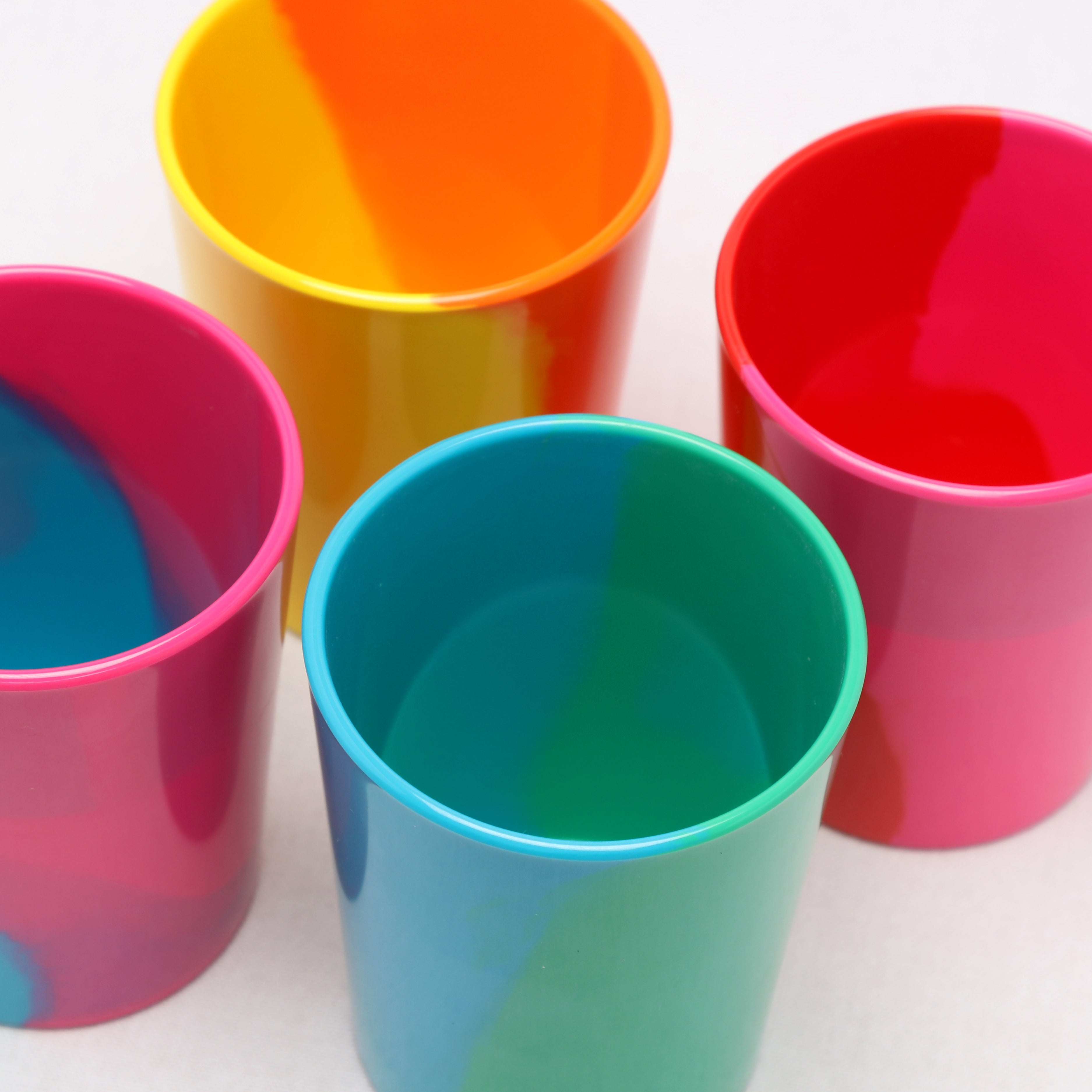 Four colorful melamine tumblers on a white background