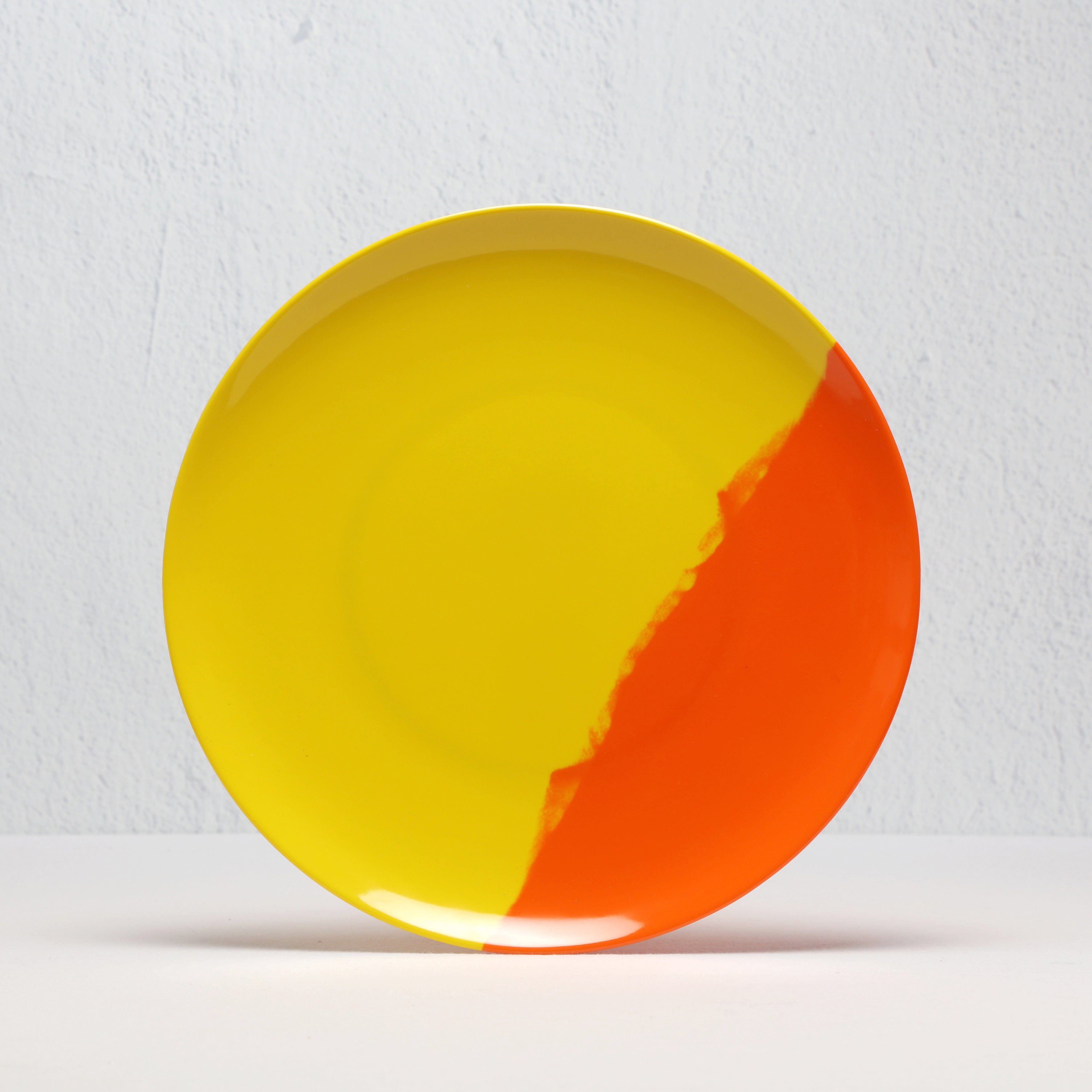 Yellow and red melamine plate on a white background