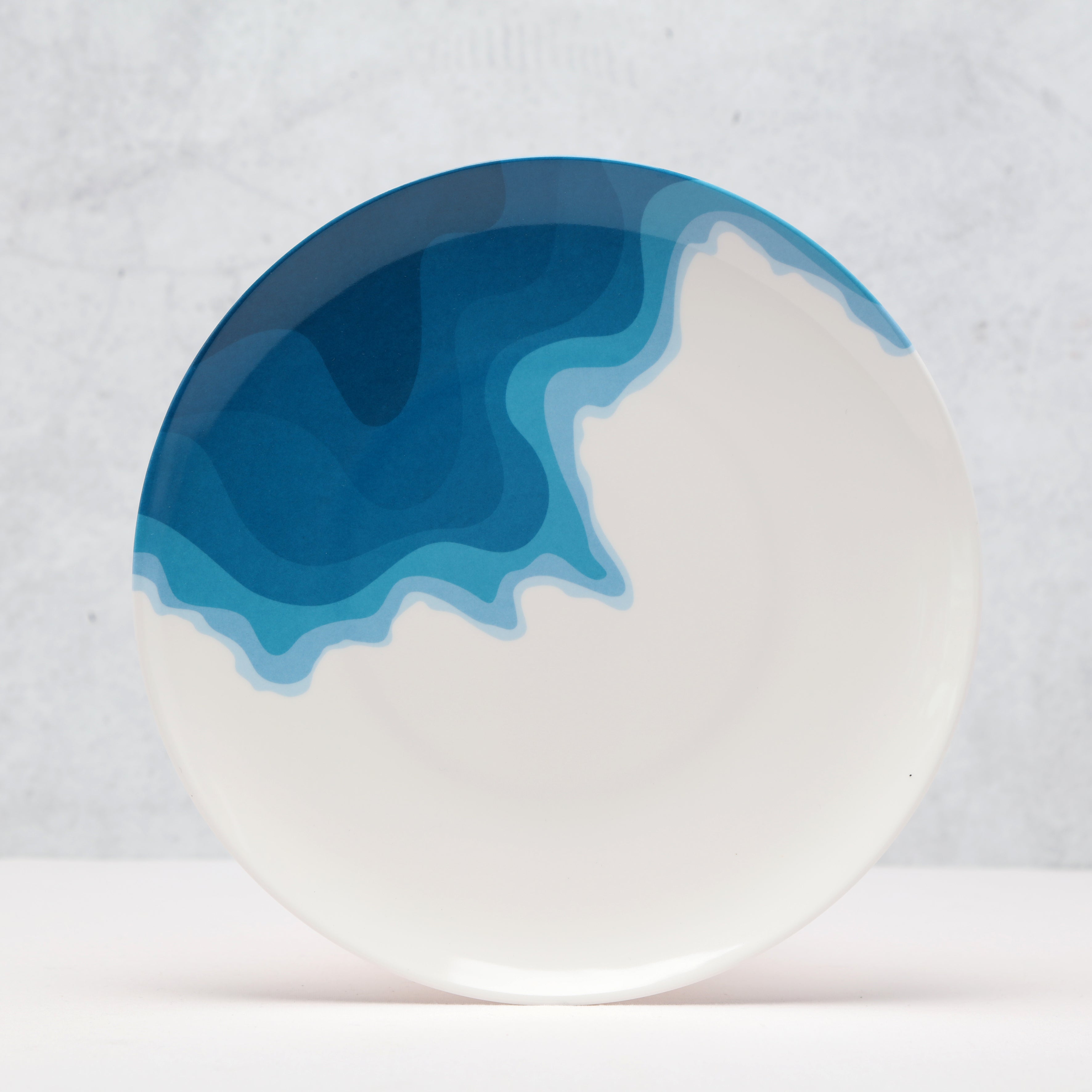 Side view of a Rick Stein Melamine Dinner Plate. Porthcurno Beach design