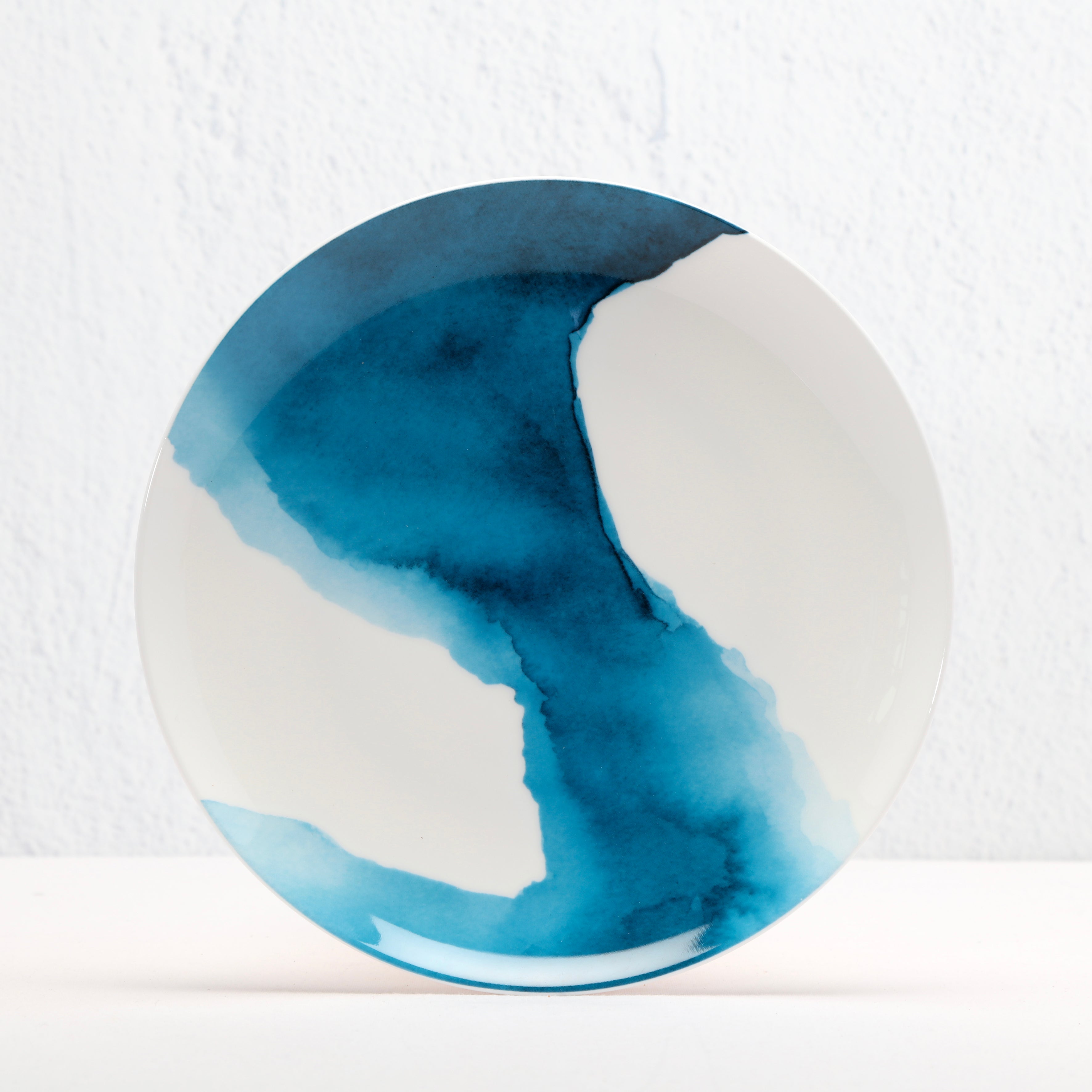 Round Bone China ceramic plate with blue watercolour design on a white background