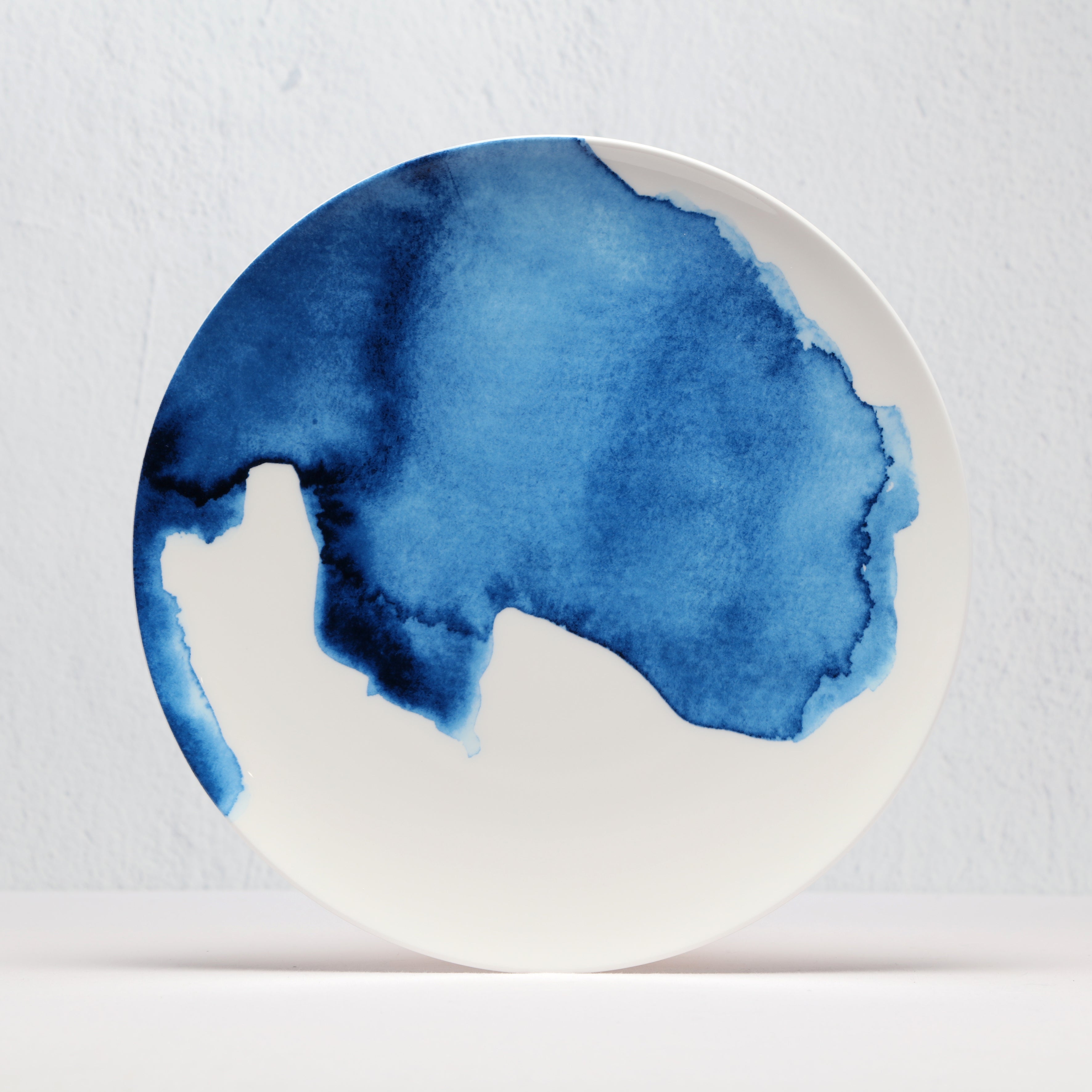 White Bone China plate with a blue watercolor design on a light gray background