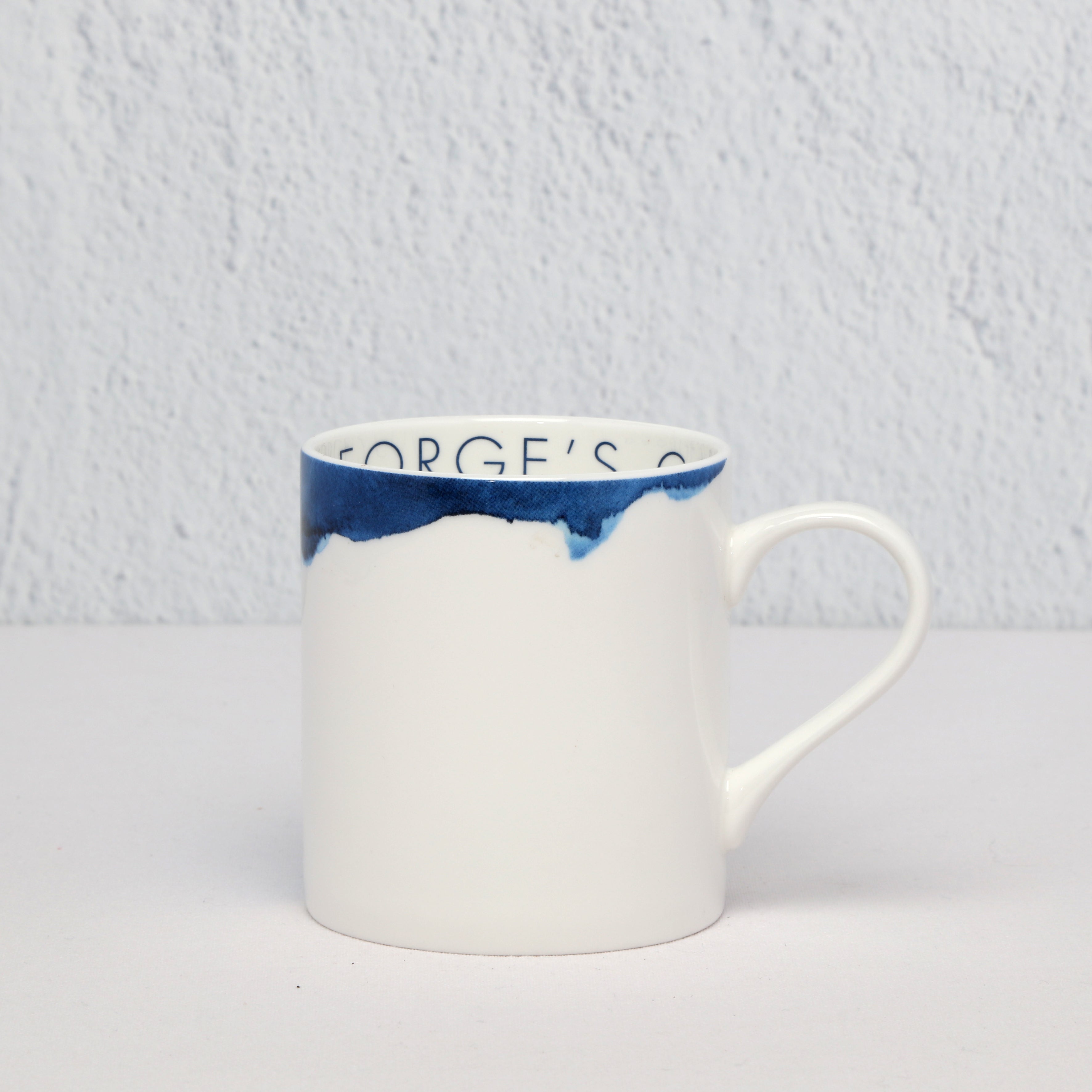Bone China White mug with blue on a light gray background
