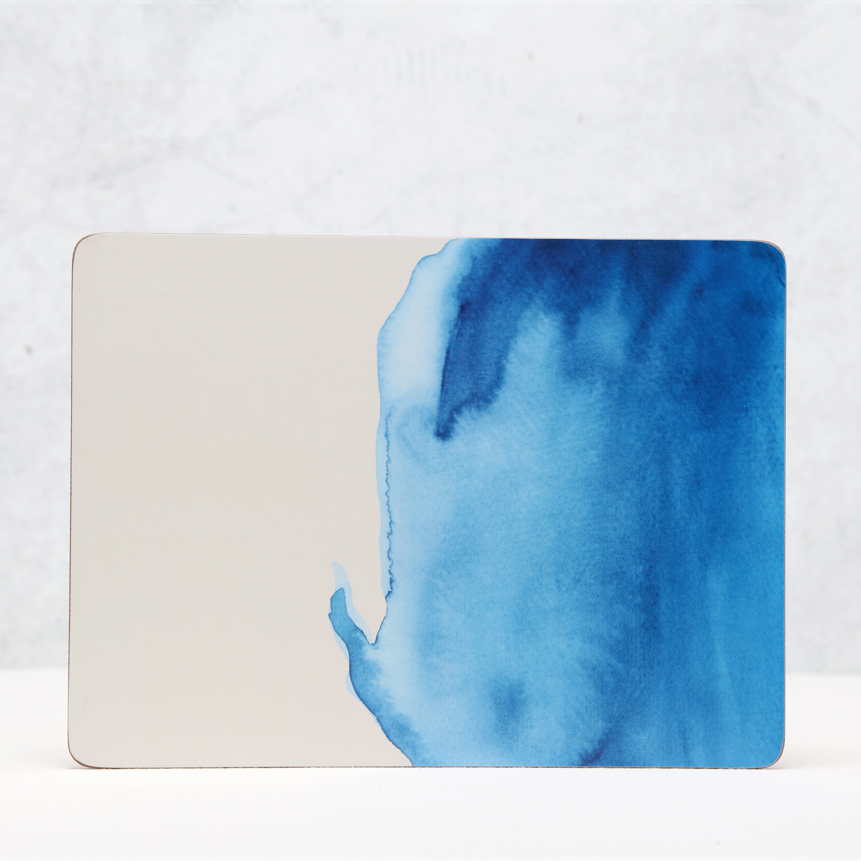Blue watercolor design on a rectangular white card with a light gray background