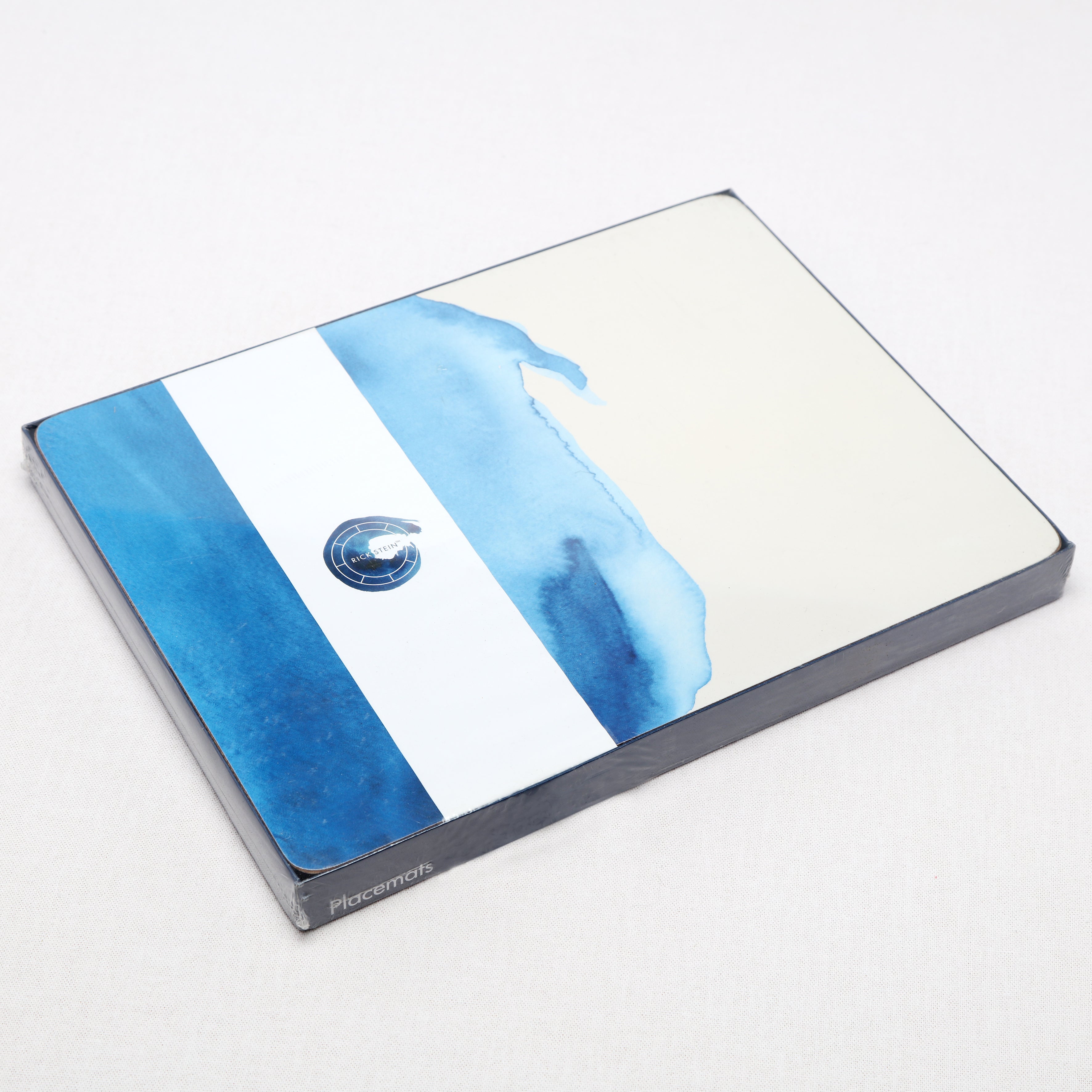 Tablemat packaging with blue and white design on a white background