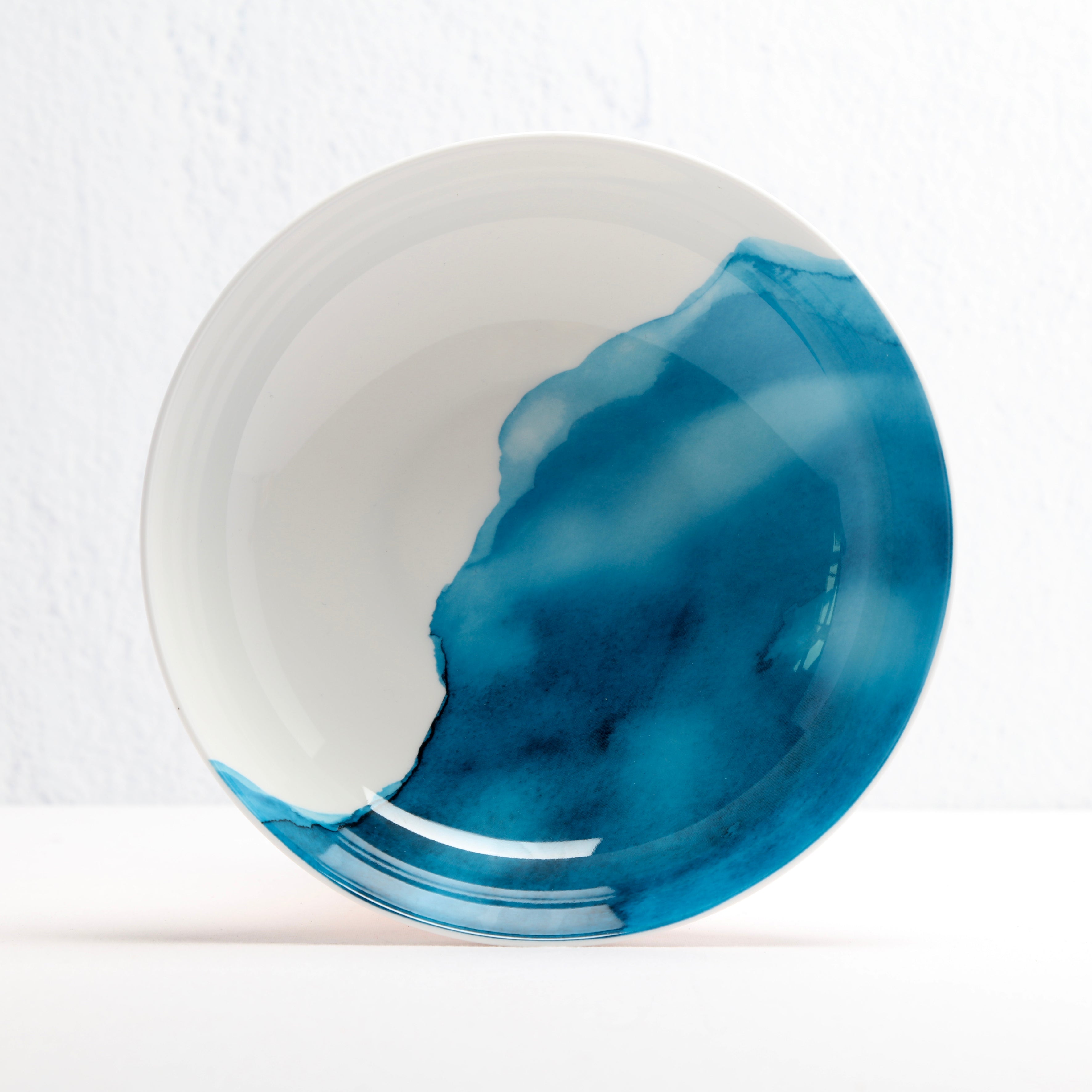 Ceramic supper bowl with blue and white design on a white background