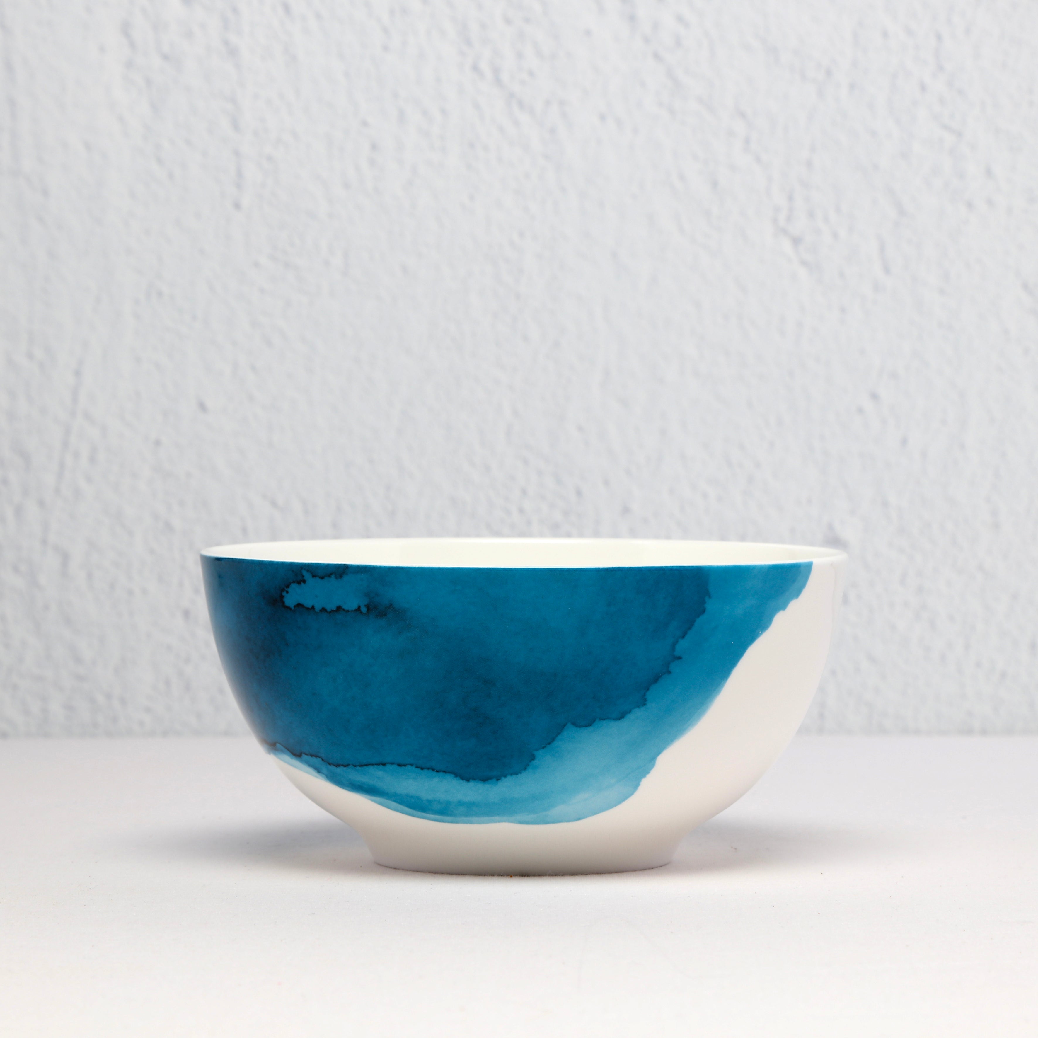 Bone China Ceramic bowl with blue and white design on a light gray background