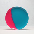Round plate with red and blue design on a white background