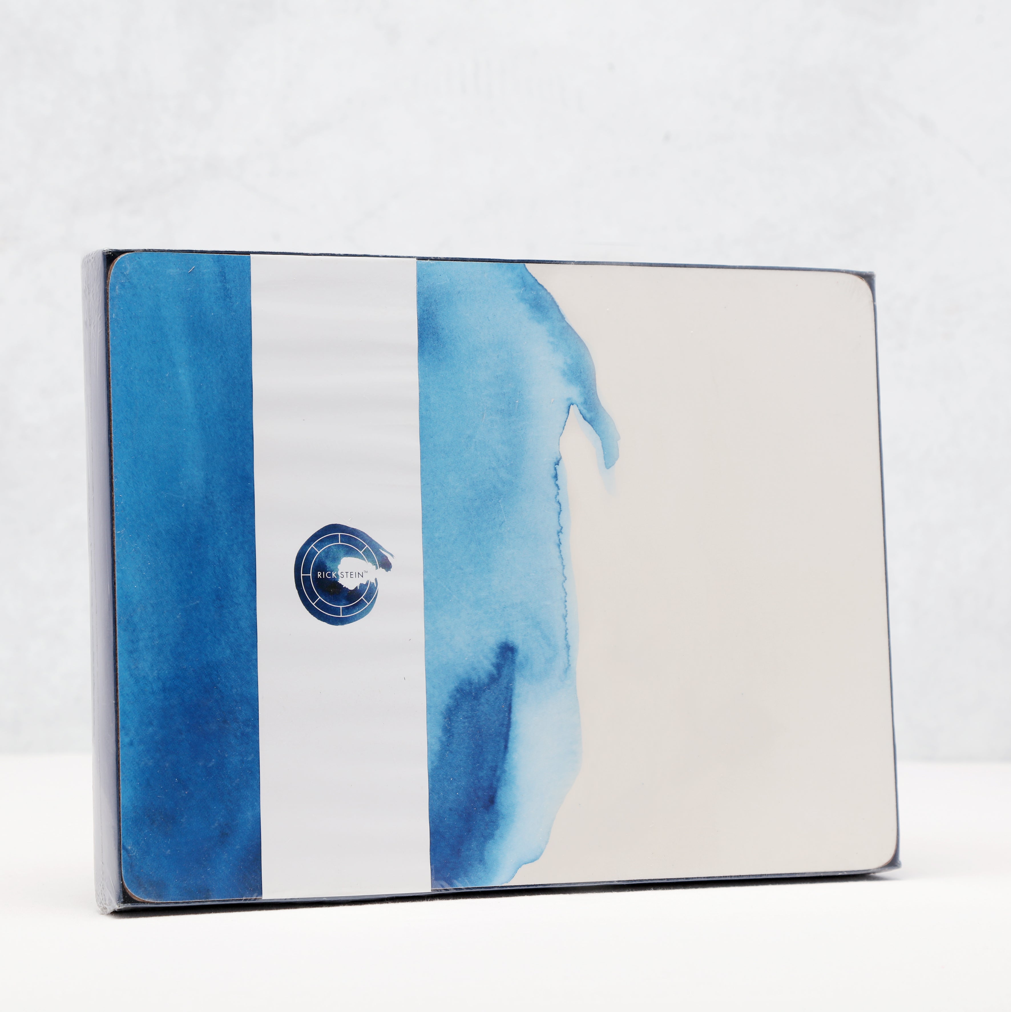 Product packaging with blue watercolour design and  brand logo on a white background